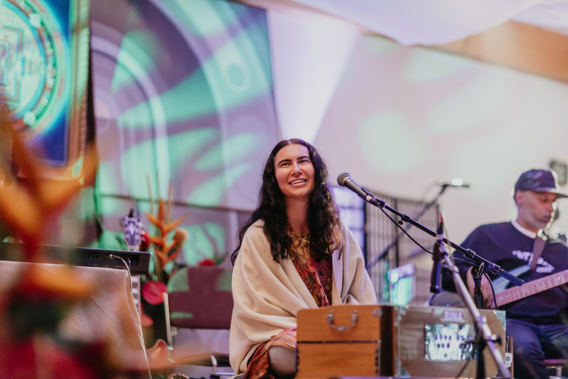 SIMRIT singing at the harmonium with her band